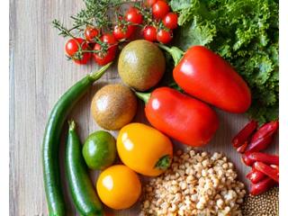 Delicious and healthy meal prep ingredients spread on a clean wooden table, emphasizing vibrant fresh produce.