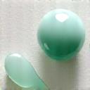 Jade roller and gua sha tool alongside a smooth, cool-toned crystal, suggesting physical healing and self-massage.